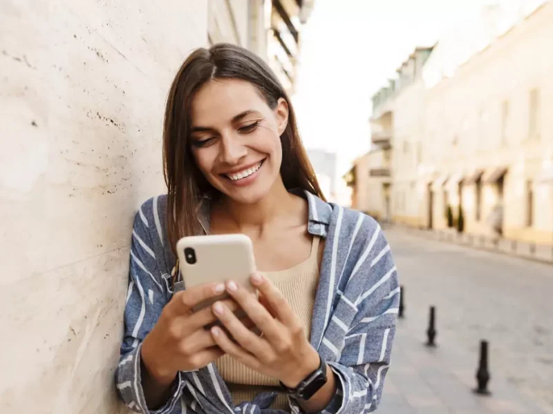 femme souriante sur son téléphone